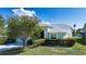 Exterior of the home showcasing its lush lawn and garden landscaping, providing great curb appeal at 9590 Knightsbridge Cir, Sarasota, FL 34238