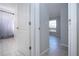 Hallway view to bathroom with shower and open area with a window at 9590 Knightsbridge Cir, Sarasota, FL 34238