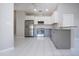 Well-lit kitchen features stainless steel appliances, white cabinetry and grey lower cabinets at 9590 Knightsbridge Cir, Sarasota, FL 34238