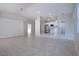 Bright living room with tile floors, leading to modern kitchen and other rooms at 9590 Knightsbridge Cir, Sarasota, FL 34238