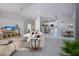 Staged living room features tile floors and an open floor plan at 9590 Knightsbridge Cir, Sarasota, FL 34238