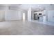 Bright living room with tile floors, leading to modern kitchen at 9590 Knightsbridge Cir, Sarasota, FL 34238