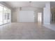 Spacious living room with tile floors and sliding glass doors to lanai at 9590 Knightsbridge Cir, Sarasota, FL 34238