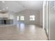 Bright living room with gray walls, tile floors and sliding glass doors to lanai at 9590 Knightsbridge Cir, Sarasota, FL 34238