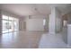 Spacious living room with tile floors and access to screened-in pool area at 9590 Knightsbridge Cir, Sarasota, FL 34238