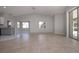 Spacious living room with tile floors, gray walls and modern kitchen view at 9590 Knightsbridge Cir, Sarasota, FL 34238