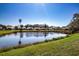 Beautiful water view of the pond surrounded by luscious green lawns and manicured landscaping at 9590 Knightsbridge Cir, Sarasota, FL 34238