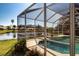 Screened pool featuring serene water and picturesque views of the neighboring lake at 9590 Knightsbridge Cir, Sarasota, FL 34238