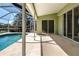 Outdoor covered patio and a pool area by a lake at 9590 Knightsbridge Cir, Sarasota, FL 34238