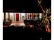 Inviting front porch with red front door, brick flooring and decorative hanging plants at 1005 S Orange Ave, Sarasota, FL 34236