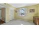 A yellow-painted room with tile flooring, shuttered windows, and a closet at 1005 S Orange Ave, Sarasota, FL 34236