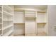 Organized walk-in closet with built-in shelving and rods for ample storage at 1005 S Orange Ave, Sarasota, FL 34236