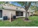 View of backyard and screened patio, with a mature tree providing ample shade at 1038 Grantham Dr, Sarasota, FL 34234