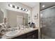 Bathroom featuring dual sinks and a glass enclosed shower at 1038 Grantham Dr, Sarasota, FL 34234