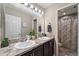 Bathroom featuring dual sinks and a shower with a curtain at 1038 Grantham Dr, Sarasota, FL 34234
