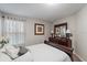 Comfortable bedroom with dresser, large mirror, and soft natural light creates a peaceful and cozy atmosphere at 1038 Grantham Dr, Sarasota, FL 34234