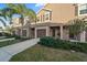 Charming townhome features a well-maintained exterior with a private garage, lush landscaping, and inviting curb appeal at 1038 Grantham Dr, Sarasota, FL 34234