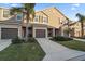 Charming townhome features a well-maintained exterior with a private garage, lush landscaping, and inviting curb appeal at 1038 Grantham Dr, Sarasota, FL 34234