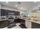 Modern kitchen with granite countertops, stainless steel appliances and dark wood cabinetry at 1038 Grantham Dr, Sarasota, FL 34234