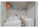 Functional laundry room with modern Samsung washer and dryer, and shelving for convenient storage at 1038 Grantham Dr, Sarasota, FL 34234