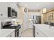 Bright kitchen with white cabinets, stainless steel appliances, quartz countertops, and tile backsplash at 13106 Deep Blue Pl, Bradenton, FL 34211