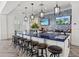 Luxurious clubhouse kitchen boasts a long island with barstool seating, pendant lighting, and modern appliances at 13106 Deep Blue Pl, Bradenton, FL 34211