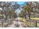 Long private driveway leading to a charming home surrounded by mature trees and fenced yard at 14204 Upper Manatee River Rd, Bradenton, FL 34212