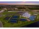 Aerial view of community with tennis courts, clubhouse and pool at 14906 Lyla Ter, Bradenton, FL 34211