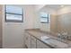 Bright bathroom featuring granite countertop, framed mirror, and a window for natural light at 14906 Lyla Ter, Bradenton, FL 34211