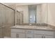 Bathroom featuring double vanity, granite counters, and glass-enclosed shower at 14906 Lyla Ter, Bradenton, FL 34211