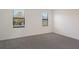 Bright bedroom with neutral carpet and two windows at 14906 Lyla Ter, Bradenton, FL 34211