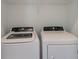 Convenient laundry area with white washer and dryer units and wire shelving at 14906 Lyla Ter, Bradenton, FL 34211
