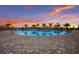 Stunning pool with palm trees reflecting in the water under a vibrant sunset sky at 14906 Lyla Ter, Bradenton, FL 34211
