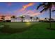 Back of the clubhouse featuring a putting green with grass and sand trap and manicured lawn at 14906 Lyla Ter, Bradenton, FL 34211