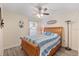 Cozy bedroom with hardwood floors, ceiling fan and a lamp at 155 Jose Gaspar Dr # 155, Englewood, FL 34223