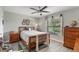 Comfortable bedroom with a queen bed, ceiling fan and hardwood floors at 155 Jose Gaspar Dr # 155, Englewood, FL 34223