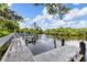 Picturesque dock on the water, surrounded by lush greenery and a serene atmosphere at 155 Jose Gaspar Dr # 155, Englewood, FL 34223