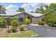 Inviting single-story home showcasing lush greenery and a paved driveway leading to the front entrance at 155 Jose Gaspar Dr # 155, Englewood, FL 34223