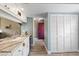 Charming kitchenette area featuring white cabinets, granite countertops, and a view into the dining room at 155 Jose Gaspar Dr # 155, Englewood, FL 34223