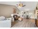 Open concept living area with wood floors, comfortable seating, and views into the dining area at 155 Jose Gaspar Dr # 155, Englewood, FL 34223