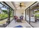 Relaxing screened patio with comfortable seating and ceiling fan at 155 Jose Gaspar Dr # 155, Englewood, FL 34223