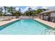 Inviting community pool area featuring ample seating and well-maintained grounds for relaxation and enjoyment at 155 Jose Gaspar Dr # 155, Englewood, FL 34223