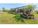 Picturesque backyard featuring lush landscaping, a screened-in pool, and inviting outdoor seating areas at 15607 White Linen Dr, Lakewood Ranch, FL 34211