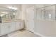 Bright bathroom featuring a granite countertop, white cabinets, a framed shower, and light-colored tile floors at 15607 White Linen Dr, Lakewood Ranch, FL 34211