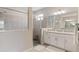 Modern bathroom with a glass-enclosed shower, granite counters, and ample vanity space at 15607 White Linen Dr, Lakewood Ranch, FL 34211