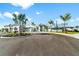 Exterior view of the community clubhouse, featuring well-manicured landscaping and ample parking at 15607 White Linen Dr, Lakewood Ranch, FL 34211