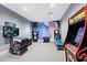 Fun game room featuring a variety of arcade games and a colorful wall mural at 15607 White Linen Dr, Lakewood Ranch, FL 34211