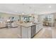 Open-concept kitchen with stainless steel appliances, large island, and access to living and dining areas at 15607 White Linen Dr, Lakewood Ranch, FL 34211