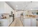 Bright, modern kitchen with stainless steel appliances, island, and a large pantry at 15607 White Linen Dr, Lakewood Ranch, FL 34211