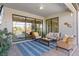 Screened-in lanai with comfortable seating, a TV, and views of the pool and backyard at 15607 White Linen Dr, Lakewood Ranch, FL 34211